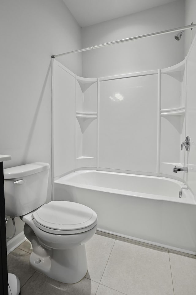 bathroom with toilet, tile patterned flooring, and  shower combination