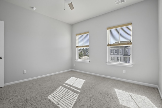 spare room with carpet, ceiling fan, and plenty of natural light