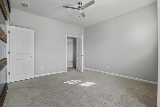 unfurnished bedroom with ceiling fan, light colored carpet, and a closet