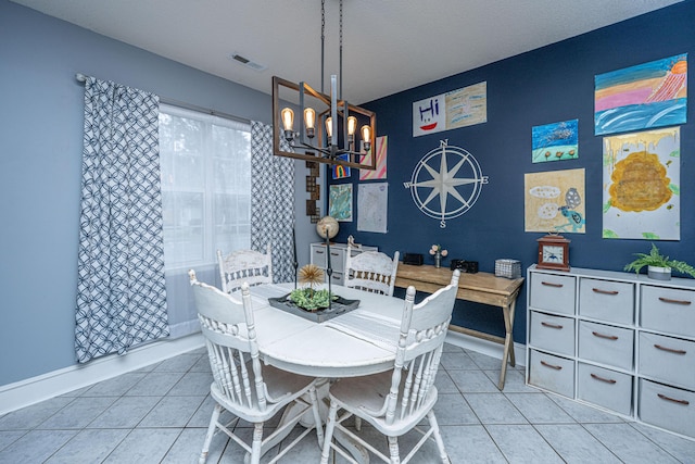 dining area with an inviting chandelier, baseboards, visible vents, and tile patterned floors