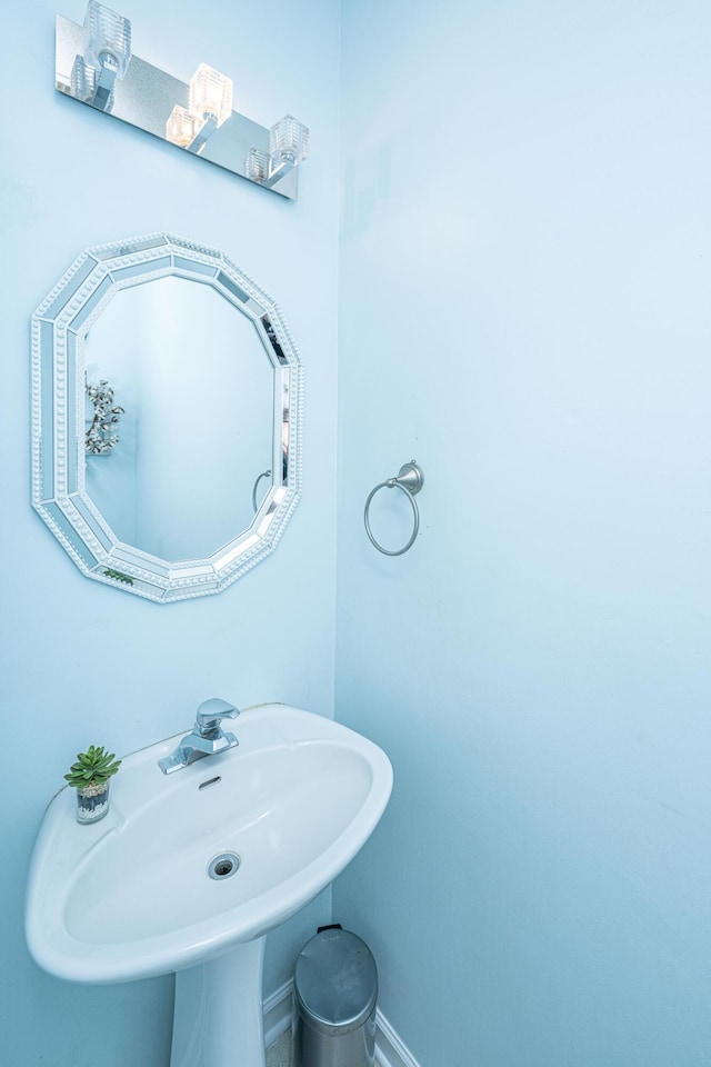 bathroom with baseboards and a sink