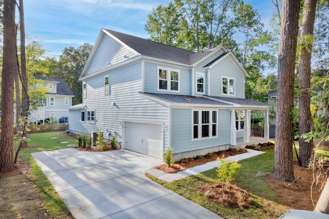 5655 Captain Kidd Rd, Hollywood, SC 29449 - traditional-style home featuring a shingled roof, a front lawn, a garage, concrete driveway, and covered porch