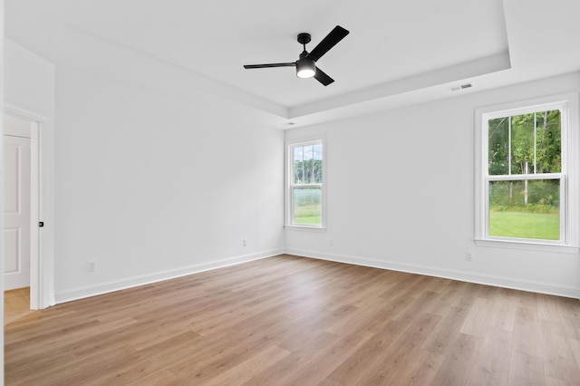 5655 Captain Kidd Rd, Hollywood, SC 29449 - spare room featuring visible vents, baseboards, ceiling fan, a tray ceiling, and light wood finished floors