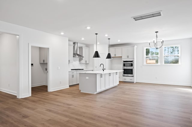 5655 Captain Kidd Rd, Hollywood, SC 29449 - kitchen with visible vents, open floor plan, gas cooktop, and wall chimney range hood