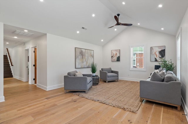 living room with ceiling fan, high vaulted ceiling, and light hardwood / wood-style flooring