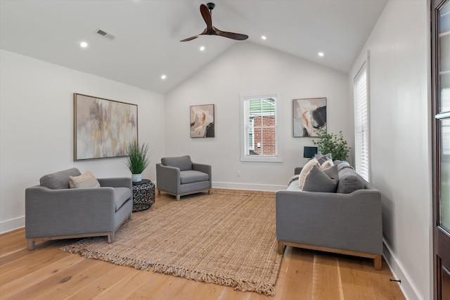 living room with hardwood / wood-style flooring, high vaulted ceiling, and ceiling fan