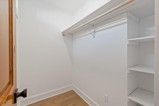 walk in closet featuring hardwood / wood-style flooring