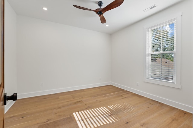 spare room featuring light wood-type flooring and ceiling fan