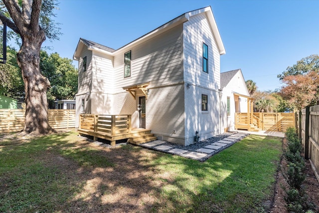 rear view of property with a lawn