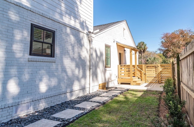 view of side of property with a lawn