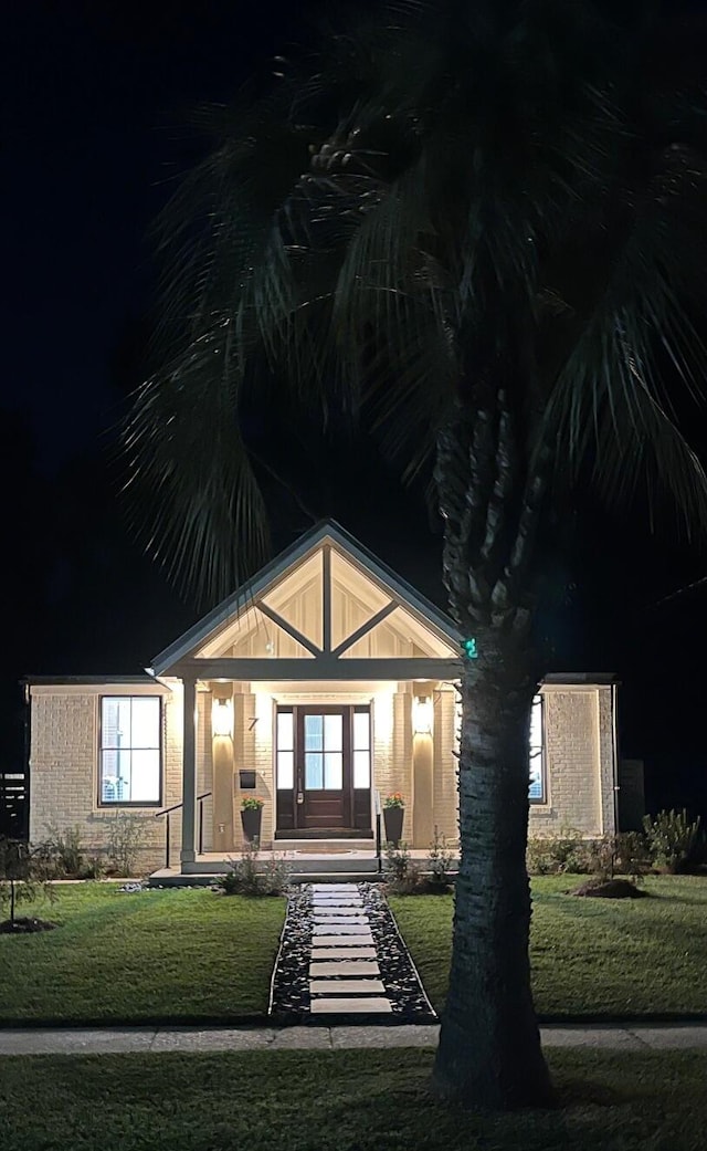 view of front of home with a yard and covered porch