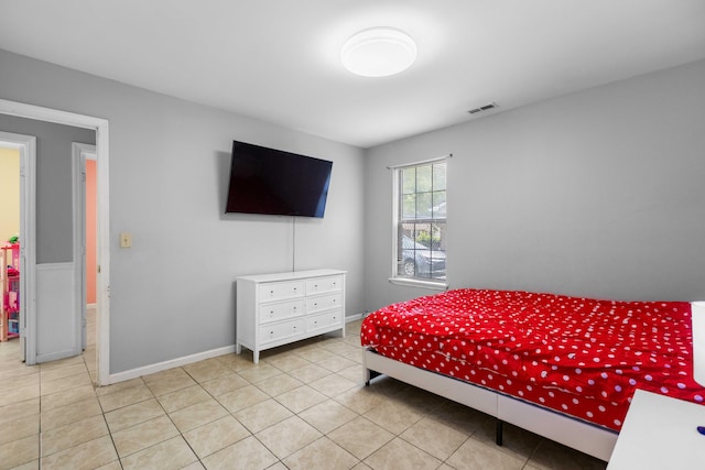 tiled bedroom with baseboards and visible vents