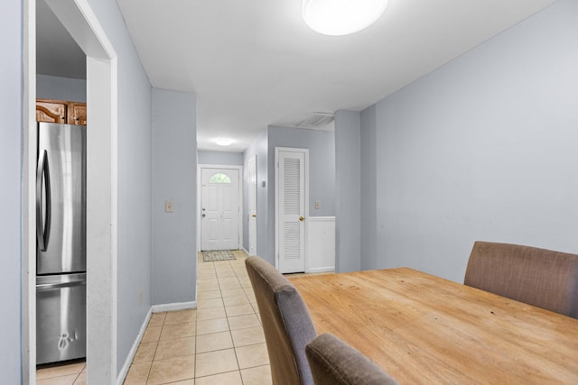 dining space with light tile patterned floors, visible vents, and baseboards