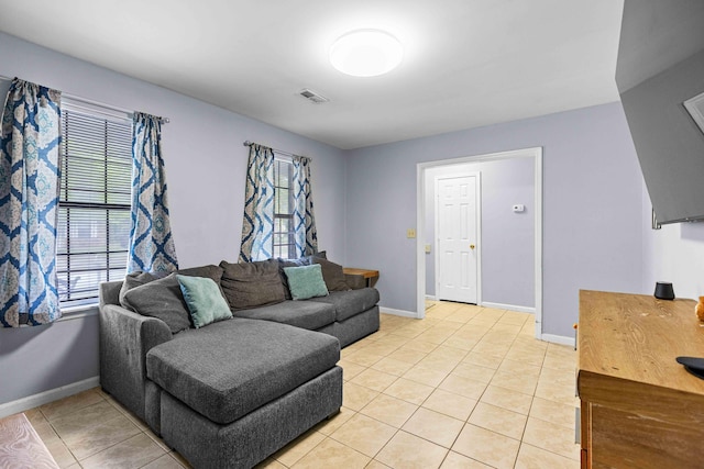 living area featuring visible vents, light tile patterned flooring, and plenty of natural light