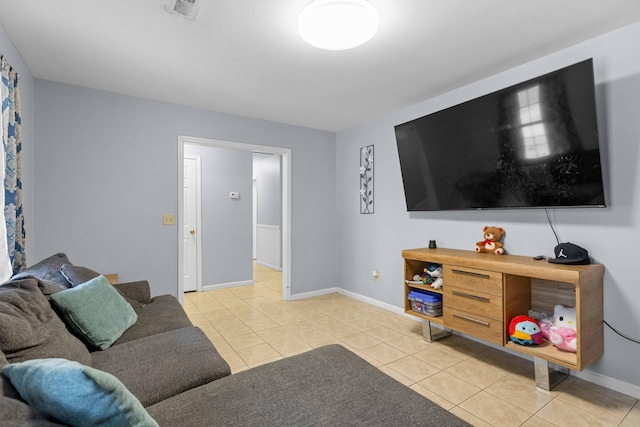 tiled living area with visible vents and baseboards
