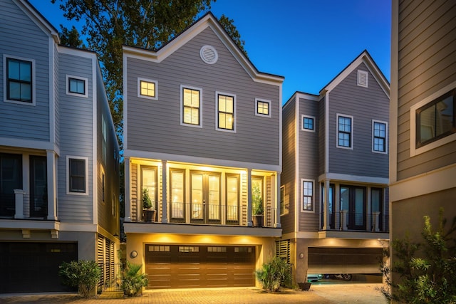 view of front of property with a balcony and a garage