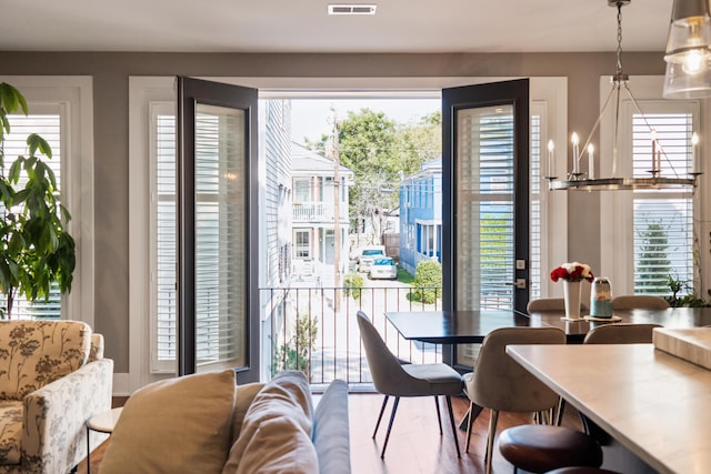 dining area featuring a wealth of natural light and a chandelier