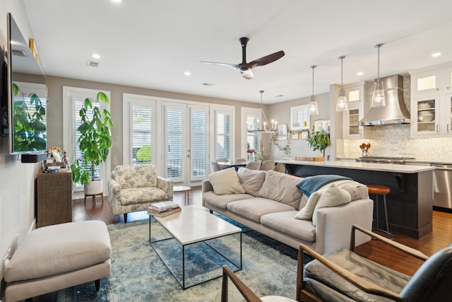 living room featuring ceiling fan and hardwood / wood-style floors