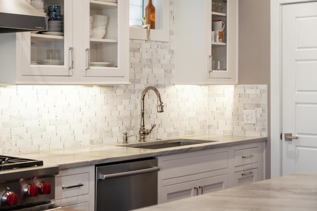 kitchen featuring appliances with stainless steel finishes, backsplash, white cabinets, and sink