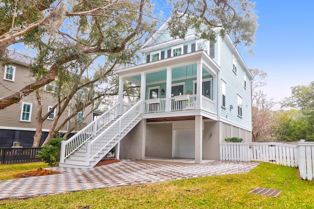 back of property featuring a porch, a patio area, and a lawn