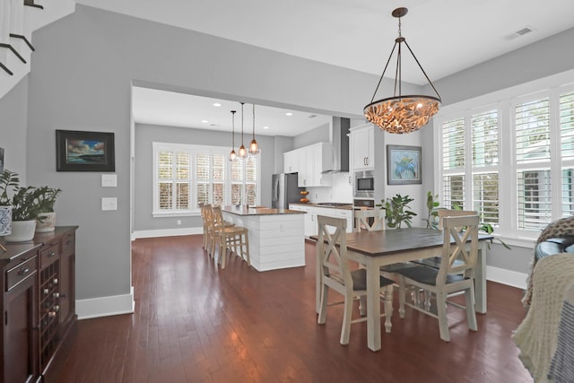 dining area with a notable chandelier and dark wood-type flooring