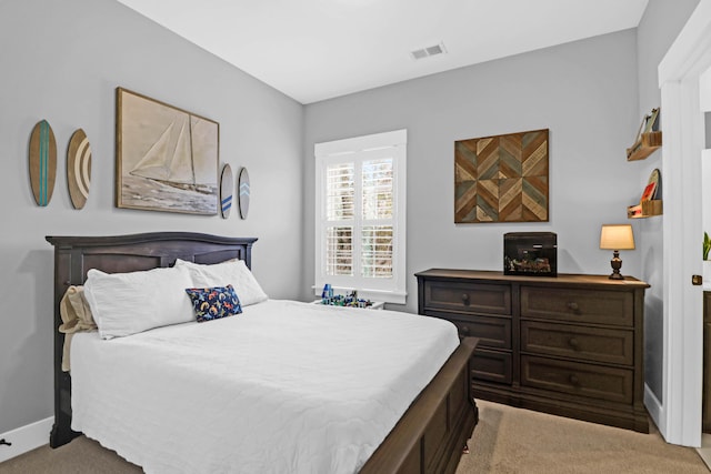 bedroom featuring light carpet