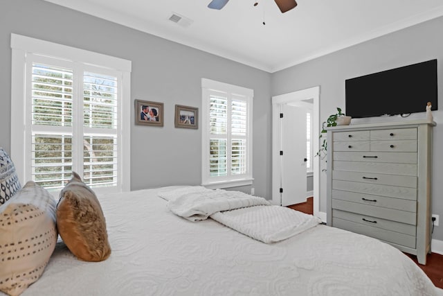 bedroom with ceiling fan, dark hardwood / wood-style flooring, and ornamental molding