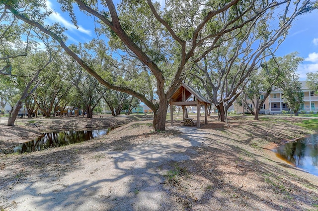 view of yard featuring a gazebo and a water view