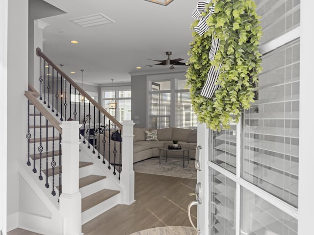 staircase with recessed lighting, ceiling fan, and wood finished floors