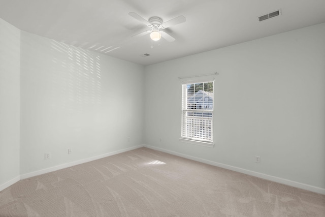 spare room featuring ceiling fan and light colored carpet