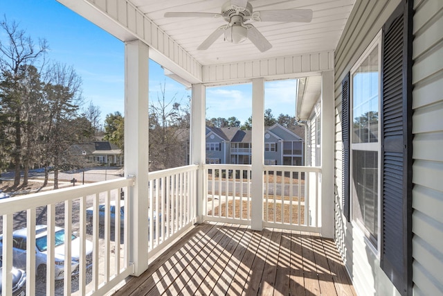 unfurnished sunroom featuring ceiling fan