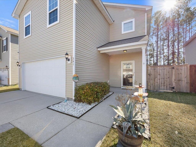 view of property featuring a garage and a front lawn