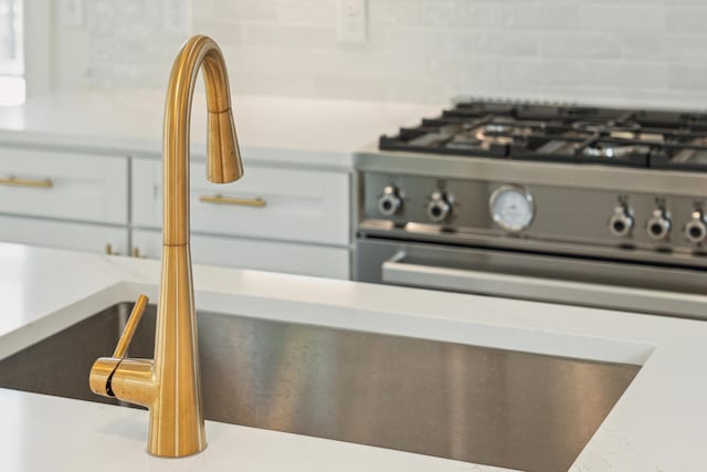 details with white cabinets and sink