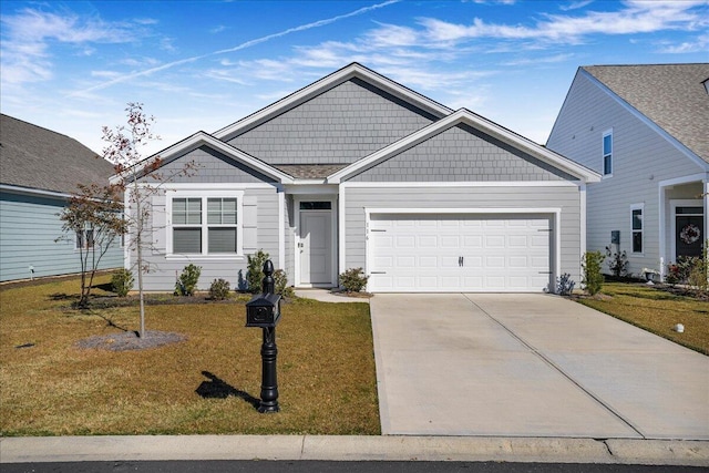 view of front of home with a front yard and a garage