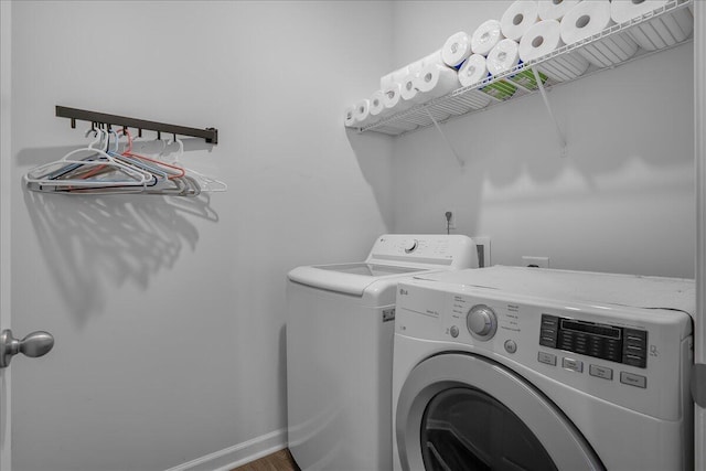 laundry area with hardwood / wood-style floors and independent washer and dryer