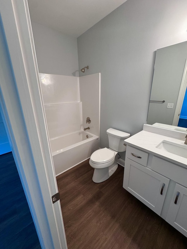 bathroom featuring vanity, shower / tub combination, wood finished floors, and toilet