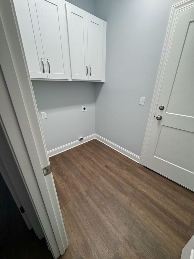 clothes washing area with baseboards, dark wood finished floors, cabinet space, and hookup for an electric dryer