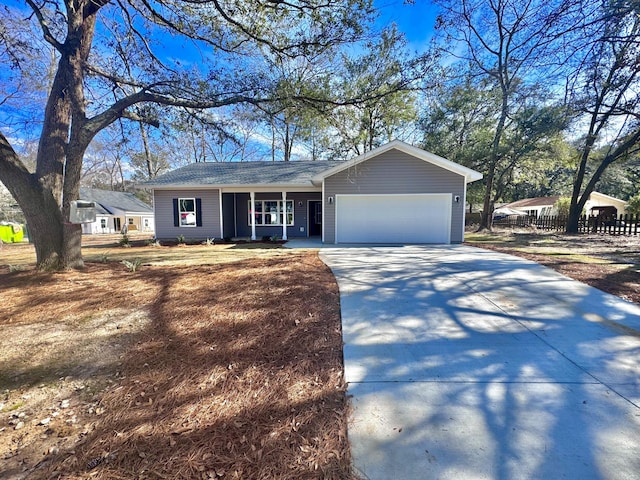 ranch-style home featuring an attached garage, fence, a porch, and concrete driveway