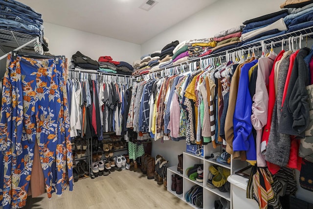 spacious closet featuring visible vents and wood finished floors