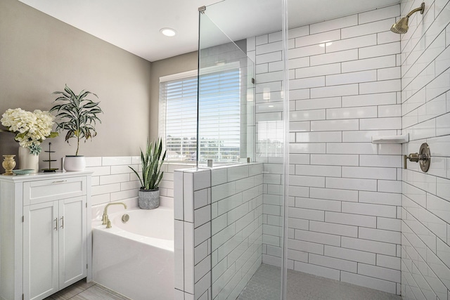 bathroom featuring tiled shower and a garden tub