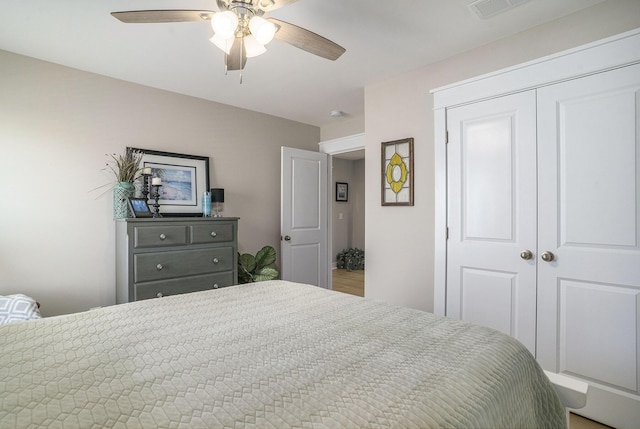 bedroom featuring a closet, visible vents, and ceiling fan