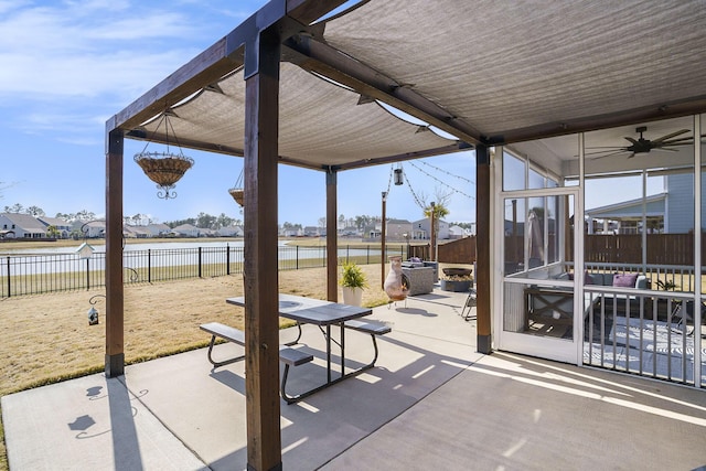 view of patio / terrace with a water view and a fenced backyard