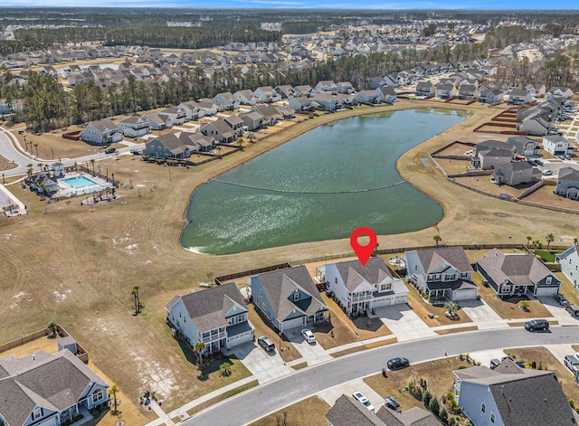 drone / aerial view with a residential view and a water view