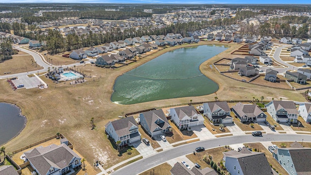 drone / aerial view featuring a residential view and a water view