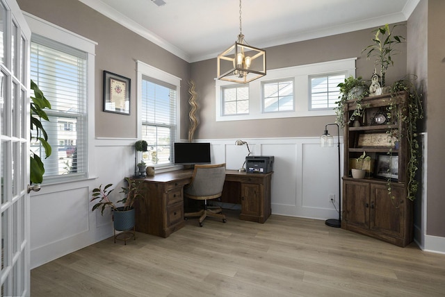 office featuring light wood finished floors, plenty of natural light, an inviting chandelier, and ornamental molding