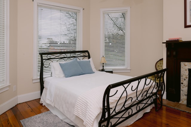 bedroom with hardwood / wood-style floors and baseboards