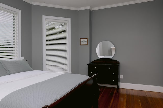 bedroom with baseboards, dark wood-style flooring, and crown molding