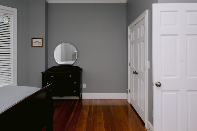 bedroom with dark wood-style floors and baseboards