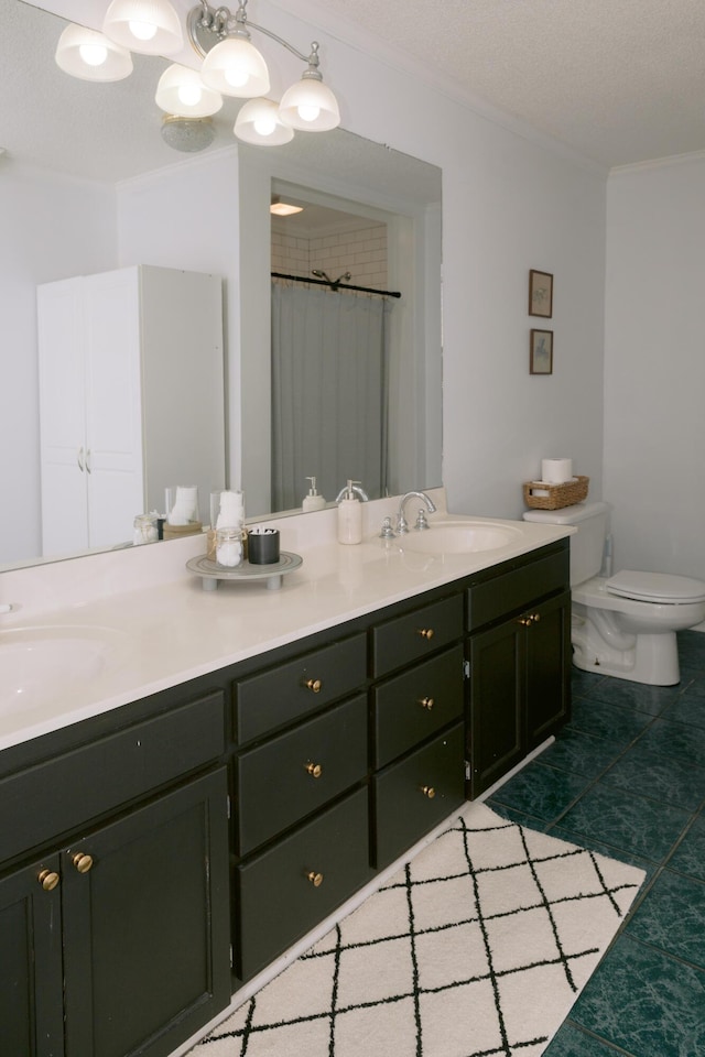 bathroom with double vanity, toilet, crown molding, and a sink