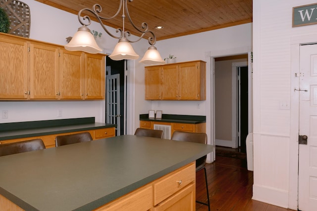 kitchen featuring a breakfast bar, visible vents, wood ceiling, dark countertops, and dark wood finished floors